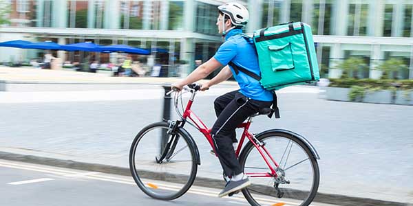 Courier on a bicycle delivering food in a city