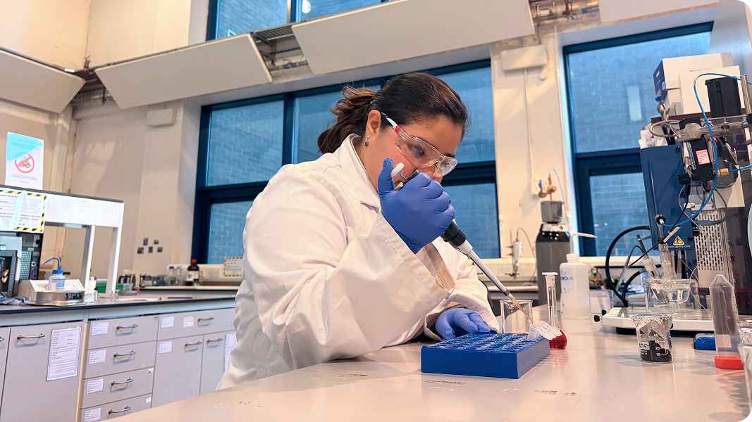 Dr Sara Velasquez in lab operating a pipette. Dr Sara Velasquez in lab operating a pipette.