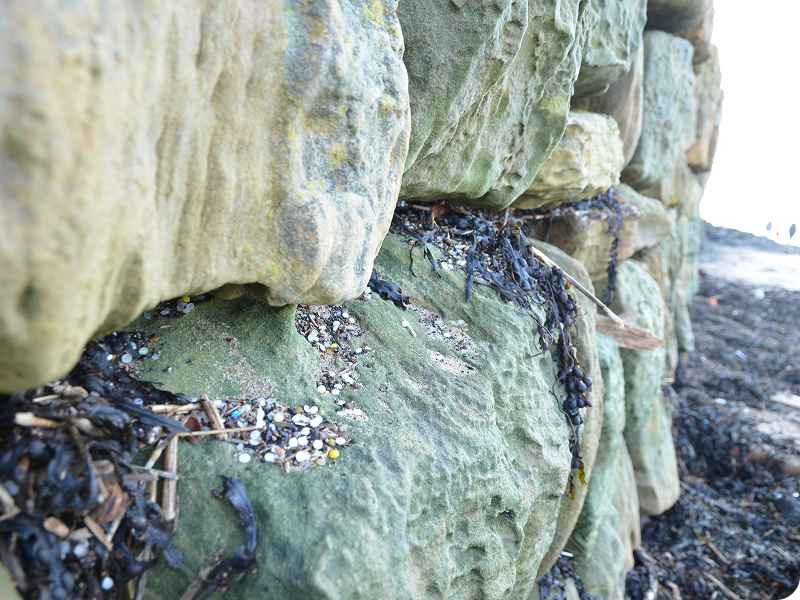 Nurdles on beach wall. Nurdles on beach wall.