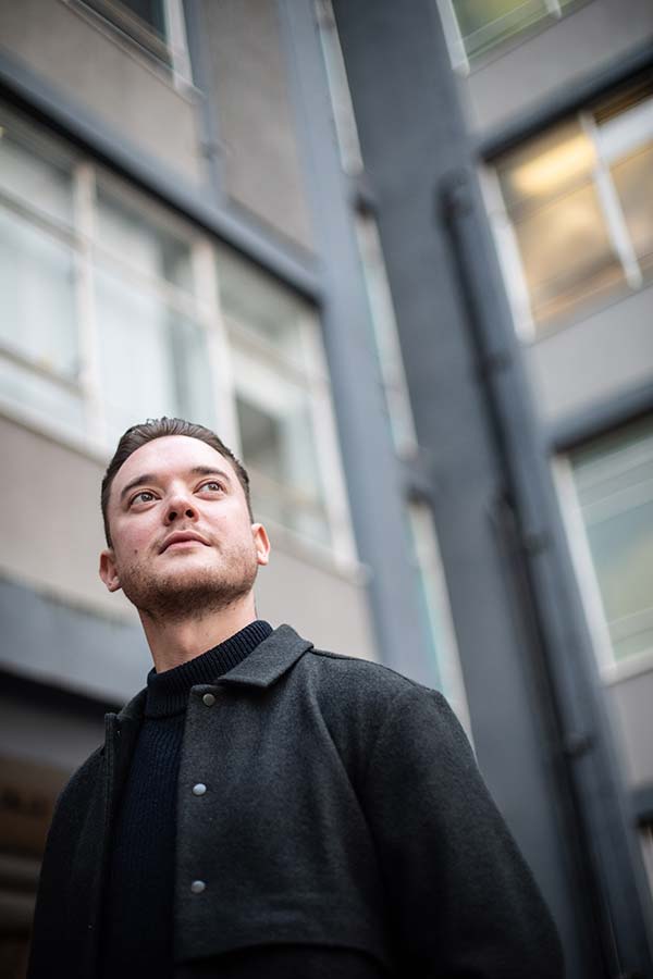 Chris McKay standing on campus.