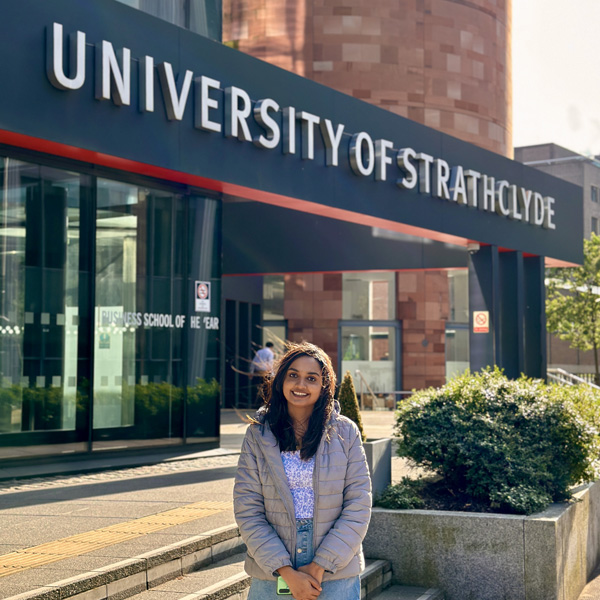 Aiswarya standing in front of the University of Strathclyde