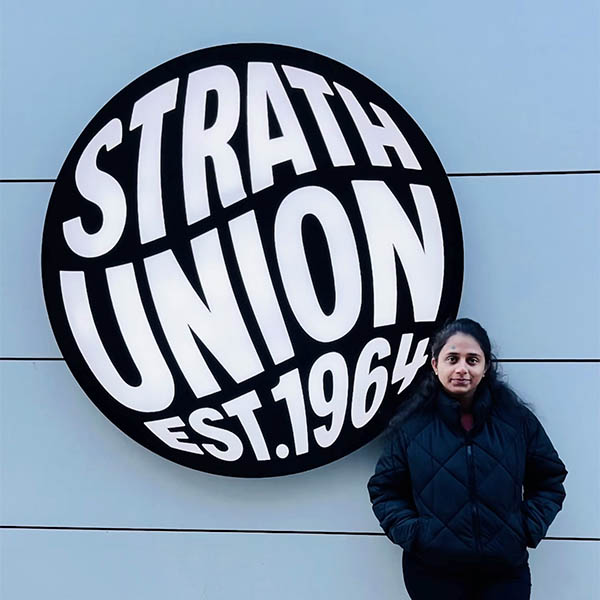 Shain Agwan next to the Strath Union sign