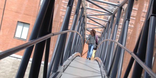Student crossing a bridge