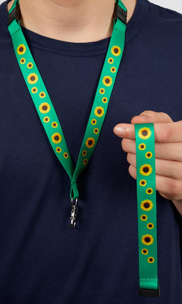 Person holding a sunflower lanyard