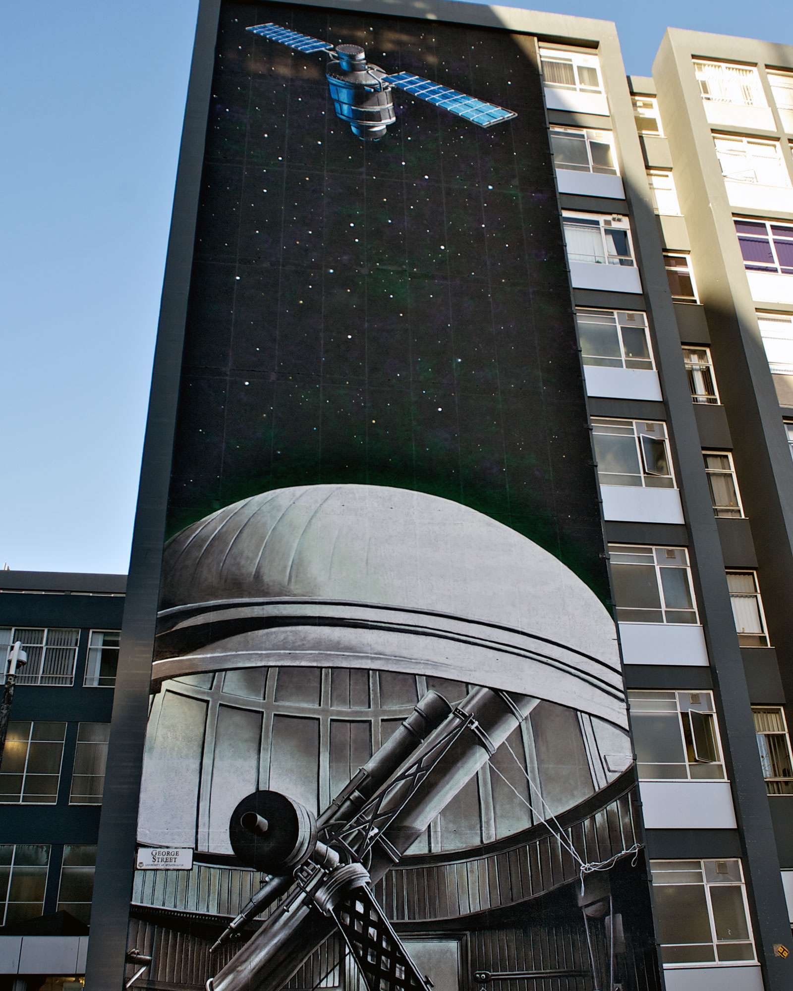 gable 1 - a satellite and telescope painted on the gable end of the graham hills building