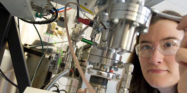 Lab worker operating equipment