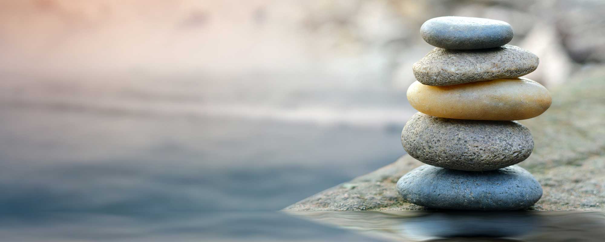 Stones balancing by a river.