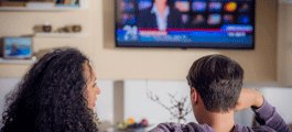 Couple watch television together