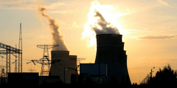 Cooling towers and pylons at sunset.