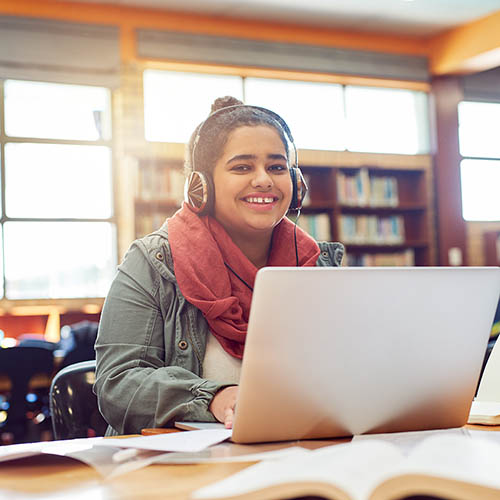 A happy student works alone.