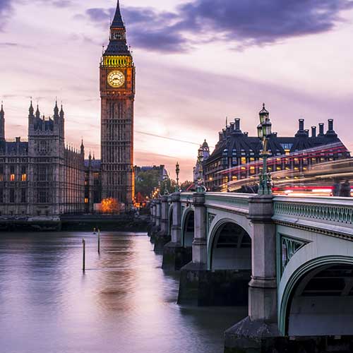 Big Ben at night and Westminster bridge with red and blue car light trails