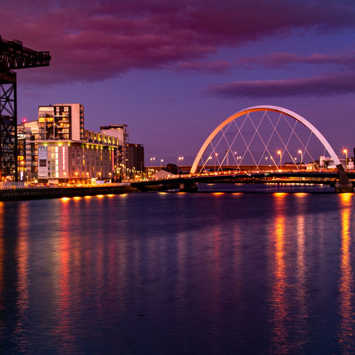 the clyde crane and squinty bridge on the river clyde at dusk