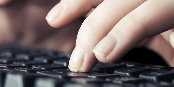 Hand typing on a keyboard