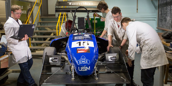 Students work on the formula student car