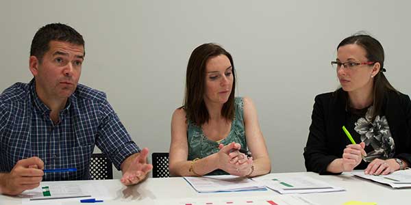 Three people at a meeting.