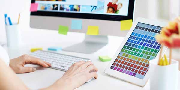 designer working with palette of colours at computer