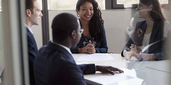 Four business people sitting and discussing at a business meeting