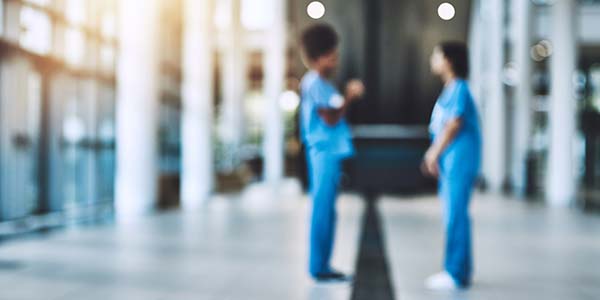 Blurred shot of two medical practitioners having a discussion in a hospital.