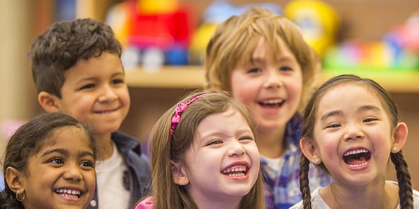 A group of young children, laughing