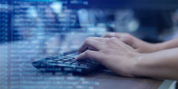 Close up of person typing on keyboard.