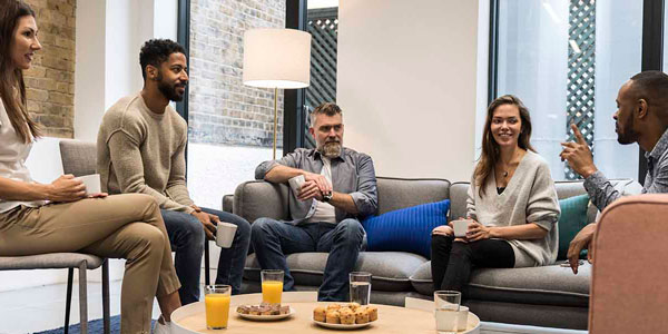 a group of people sit together in discussion