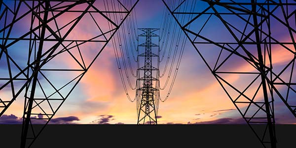 Pylons under colourful sky.