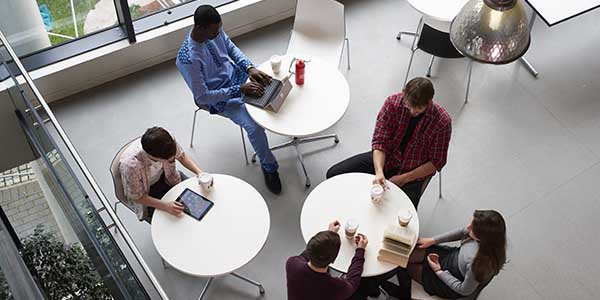 Students in breakout area socialising and studying