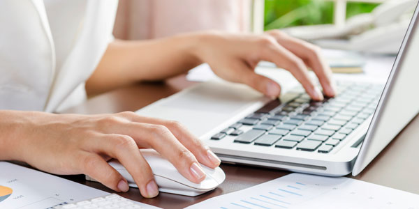 close up of a person typing on a laptop computer