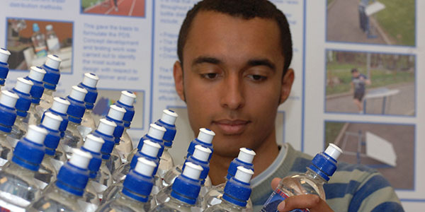 DMEM student holding bottles of water