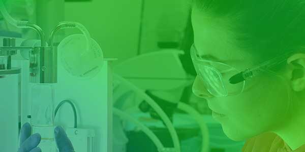 Close-up of researcher in a lab, green gradient overlay.