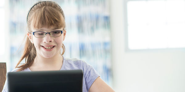young girl with a visual impairment using a tablet computer