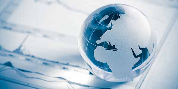 Glass globe of a map of Europe map and stock market chart on newspaper background