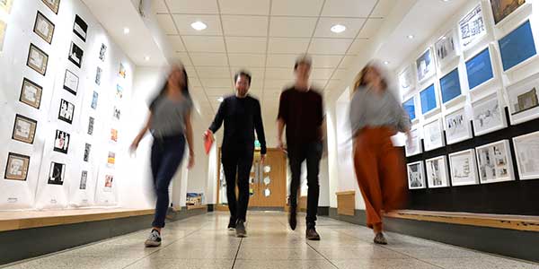 Students walking down corridor in Department of Architecture.