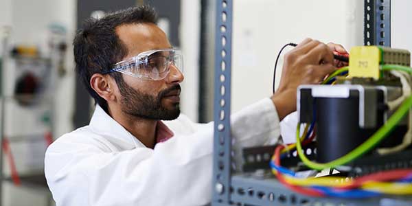 Researcher in lab conducting an experiment.