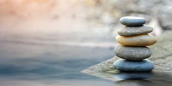 Stones balancing by a river.