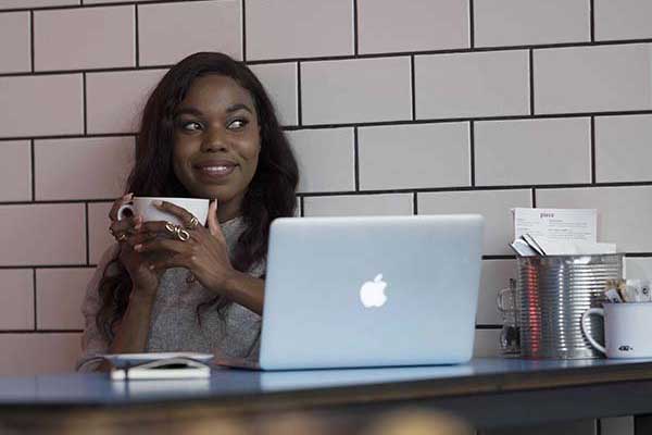 Student drinking coffee in a cafe.