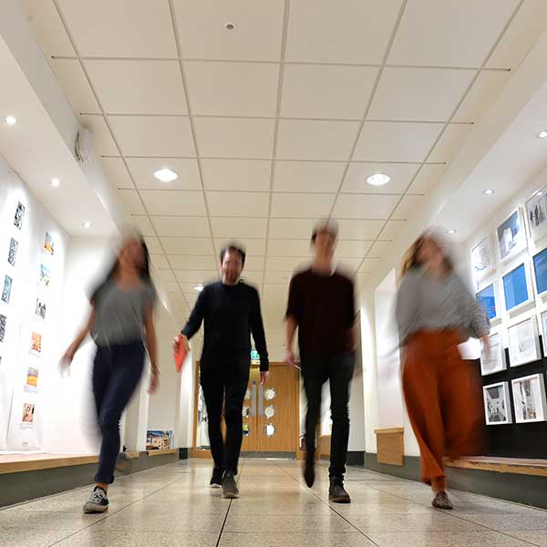 Long exposure of students walking in corridor.