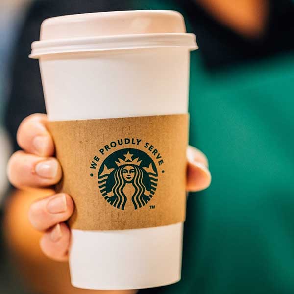 Takeaway cup with Starbucks logo.