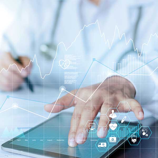 Abstract image of doctor looking at tablet, graphs overlayed.