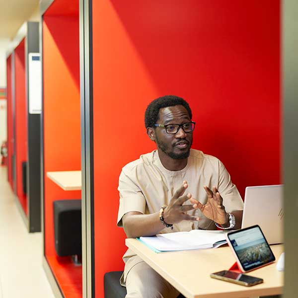 Student sitting in a pod in the Business School.