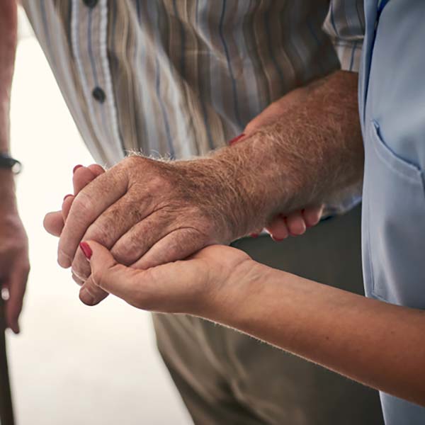 Nurse helping person to walk.