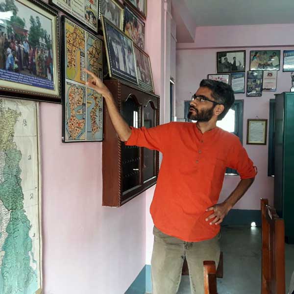 Person pointing to a map during field visit 