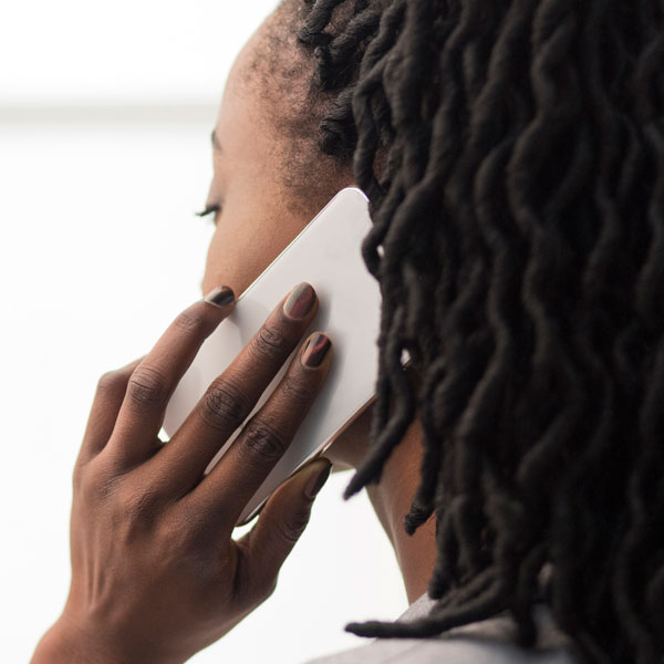 side profile of a woman with a mobile phone to her ear