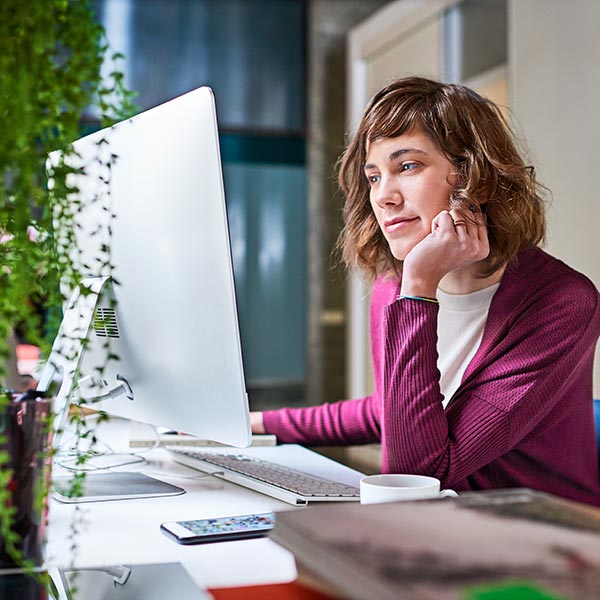 Woman sitting at desk in home office.