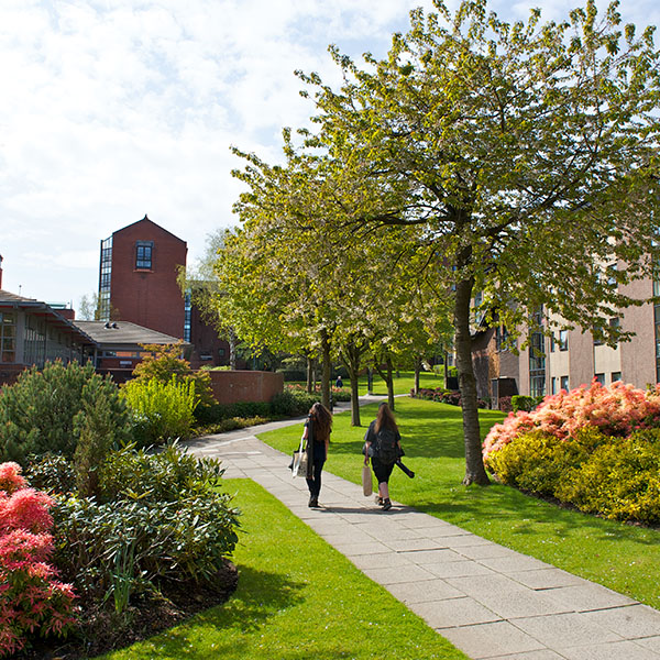 Students walking through the garden at Birkbeck Court, university accommodation