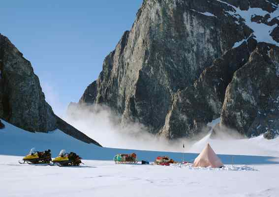 This image shows a snowy survey camp among Antarctic mountains