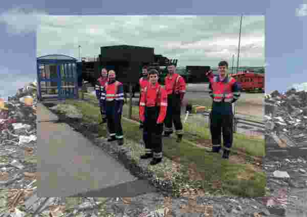 Men in high vis work gear stand at the side of a path