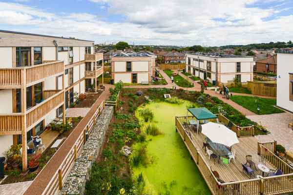 Apartment blocks surround a pond