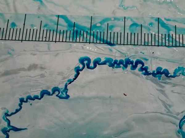 A miniature model of a meltwater channel over an ice block