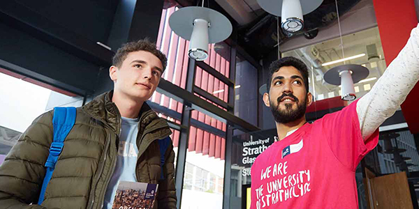 A student ambassador welcoming a young person to Strathclyde